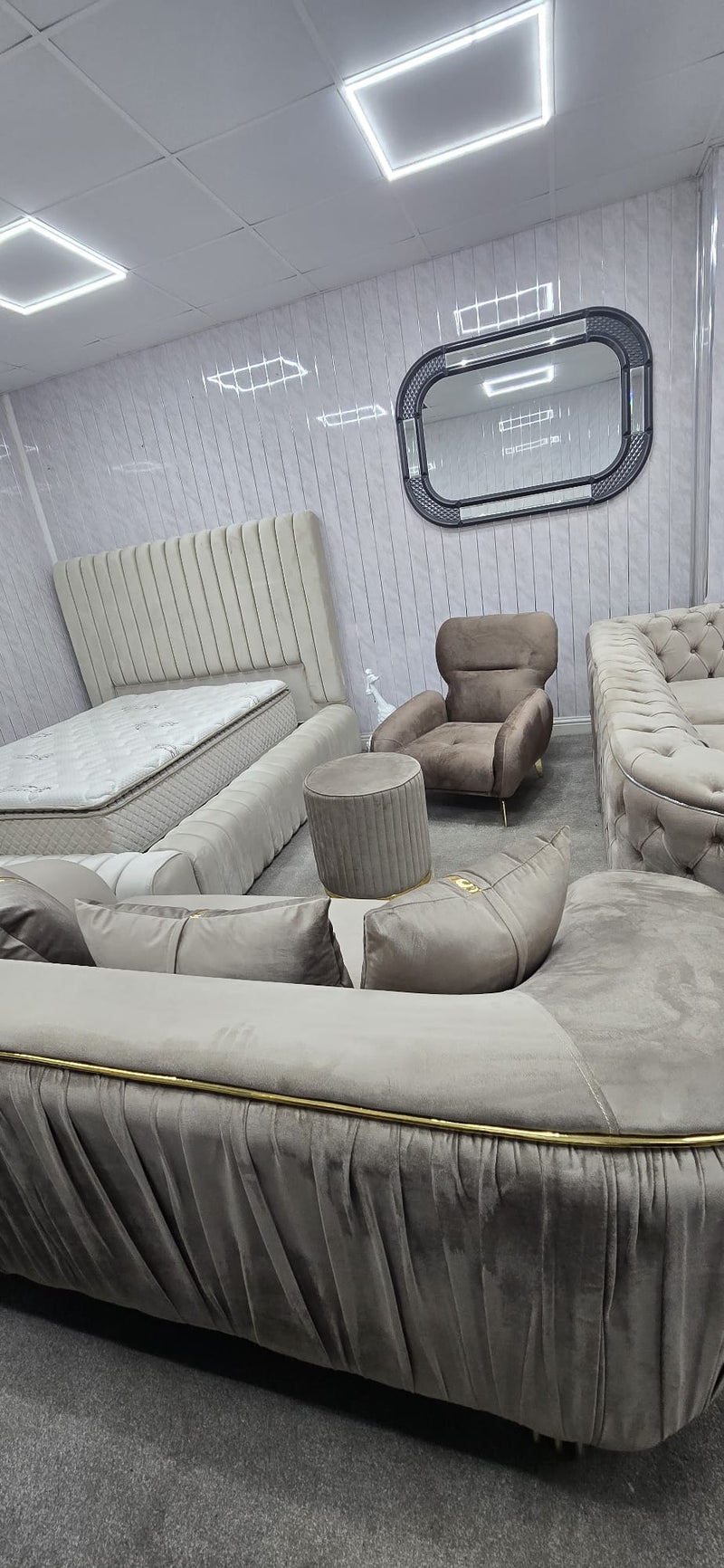 Modern living room with gray sofa, armchair, and ottoman.