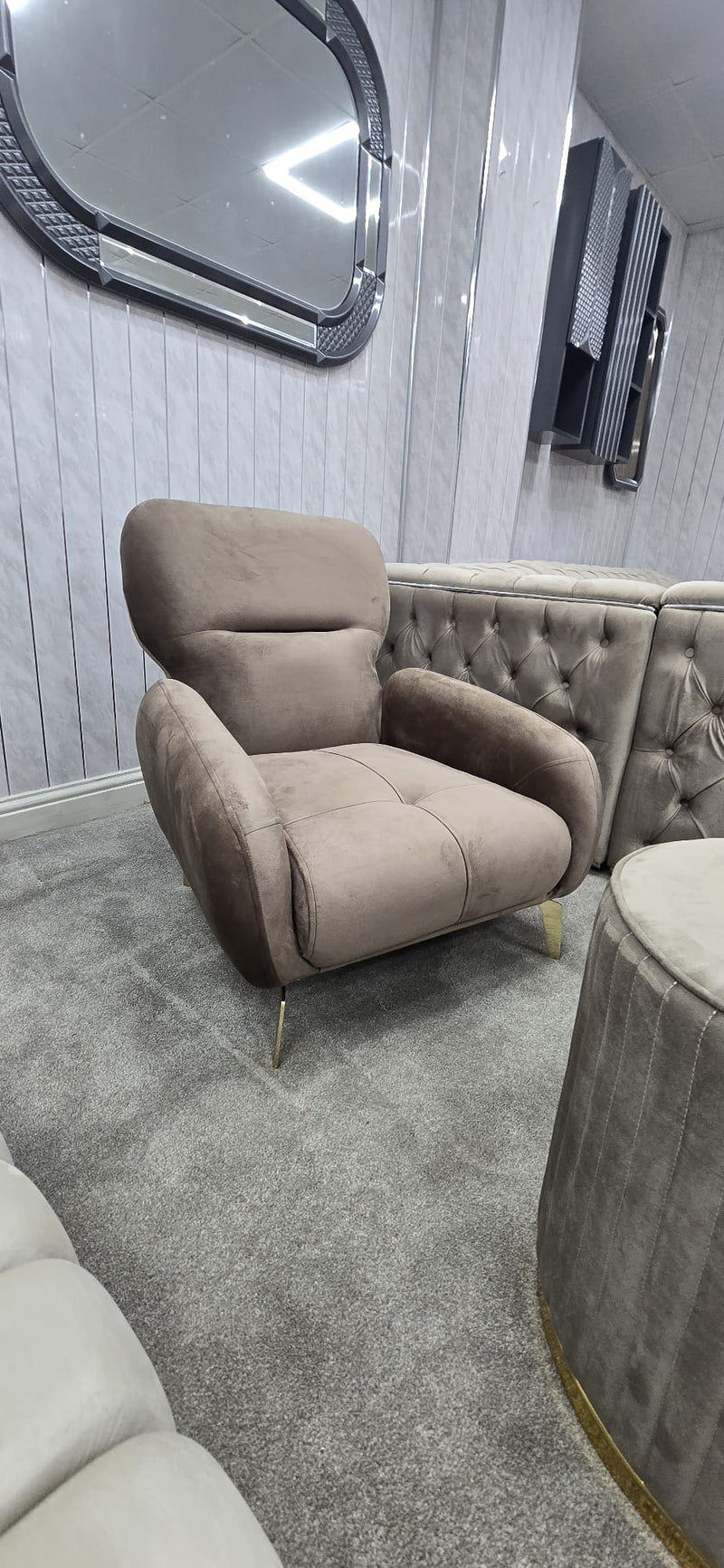 Beige armchair in a room with gray carpet and wall.