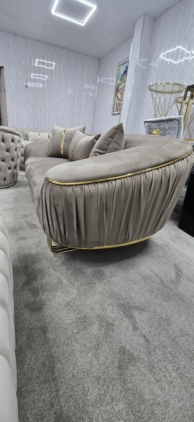 Beige sofa with tufted design in a modern living room setting